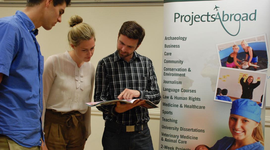 Leads have the volunteer projects and internships explained during an event. Projects Abroad staff talk to potential volunteers during an information event in the UK.